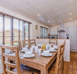 A dining area with a table set for breakfast at Lancaster Lodge in Fair Oak