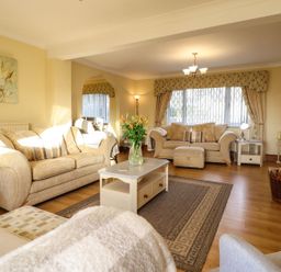 A living room with sofas and a coffee table at Llwyn Derw in Talybont