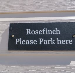 A sign that says Rosefinch Please Park here at Rosefinch Cabin Staintondale near Scarborough
