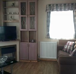 A living room with a television and sofa at Coopers Beach Holiday Park - Holiday Accommodation 3999 Mersea Island