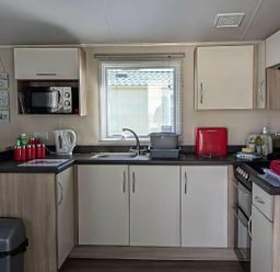 A kitchen with appliances and utensils at Coopers Beach Holiday Park - Holiday Accommodation 6404 Mersea Island