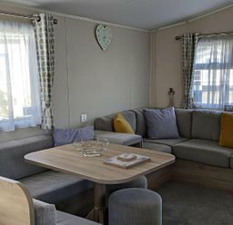 A living room with a sofa and table at Coopers Beach Holiday Park - Holiday Accommodation 6404 Mersea Island