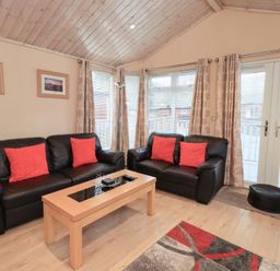 A living room with sofas and a coffee table at Kingfisher Lodge Grasmere 33, White Cross Bay near Windermere