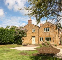 A house and garden with a pathway and trees at The Old Bakery in Banbury
