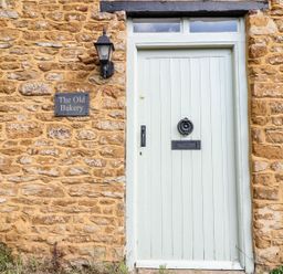 An entrance door with a sign at The Old Bakery in Banbury