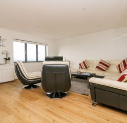 A living room with a sofa and armchair at Praa Waves in Penzance