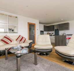 A living room with a sofa and coffee table at Praa Waves in Penzance