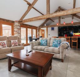 A living room with a sofa and coffee table at Pillar Barn Driffield