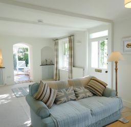 A living room with a sofa and lamp at Mount Pleasant in Padstow