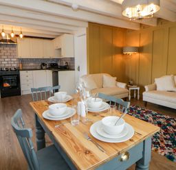 A dining room with a table and chairs at Shearers in Llandysul