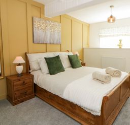 A bedroom with a bed and nightstand at Shearers in Llandysul