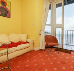 A living room with a sofa and coffee table at Val's Seaview in Ilfracombe