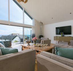 A living room with a sofa and a coffee table at 2 Remera in St Ives