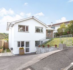A house with windows and front yard in Orchard View St. Austell