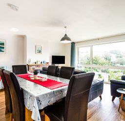 A dining room with a table and chairs at Orchard View in St. Austell