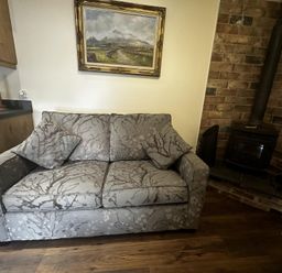 A living room with a sofa and a fireplace at The Rocks in Newry