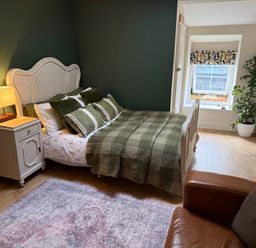A bedroom with a bed and nightstand at Studio Apartment at High Dyke Farm in Cockermouth