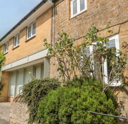 An outdoor view of a building with windows and greenery at Greenham Rise Norton-Sub-Hamdon