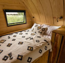 A bedroom with a bed and window at Glamping pod-Luxury Glamping Retreat in Battle