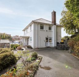 A house with a garden and seating area at Tymelyn in Aberystwyth