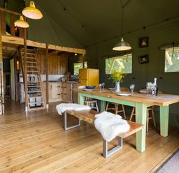 A dining room with a table and chairs at Badger - Luxury Glamping Retreat in Battle