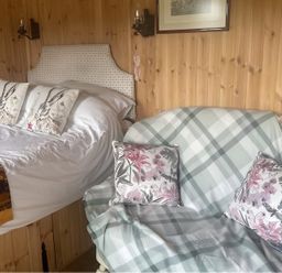 A bedroom with a bed and sofa at Tylands in Camelford