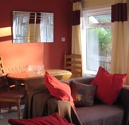 A living room with a table and chairs at Satchwell Chalet Inverness