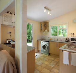 A kitchen with a washing machine and sink at Satchwell Chalet in Inverness