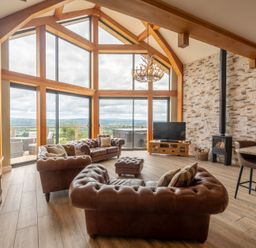 A living room with a couch and television at Valley View Lodge 1 Preston
