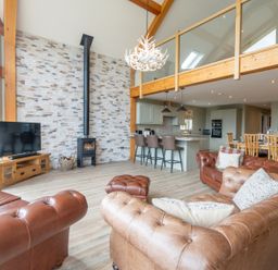 A living room with a fireplace and television at Valley View Lodge 1 in Preston