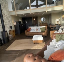A living room with a fireplace and dining area at Pendle View Preston