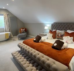 A bedroom with a bed and a bathtub at Pendle View in Preston