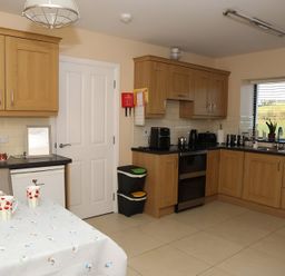 A kitchen with cabinets and appliances at The Farmhouse in Omagh