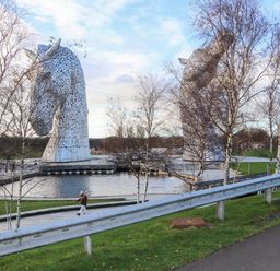 A sculpture of horses next to a water body at Beechtree Timber Lodge 69A Denny