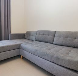 A sofa next to a window at Beechtree Timber Lodge 69A in Denny