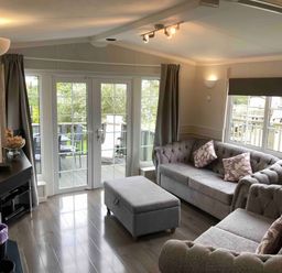 A living room with sofas and an ottoman at Caravan 38 in Newport