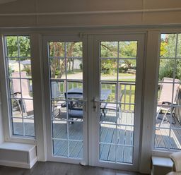 A living room with patio doors viewing a deck at Caravan 38 in Newport