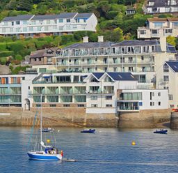 Buildings near water with boats in the bay at Villa 8, Estura Salcombe