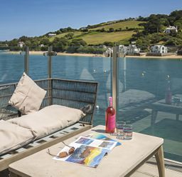 An outdoor seating area with a view of water at Villa 8, Estura in Salcombe
