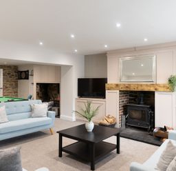 A living room with a coffee table and a television at 6 Front Street