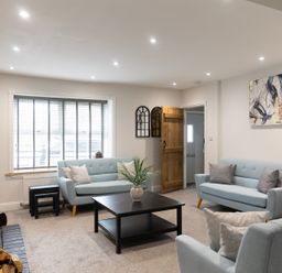 A living room with two sofas and a table at 6 Front Street