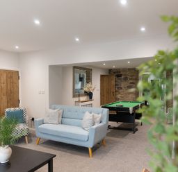 A games room with sofas and a pool table at 6 Front Street