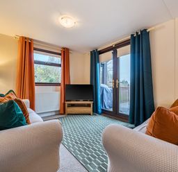 A living room with a television and sofa at Cabin 1 Moffat Manor Beaufort