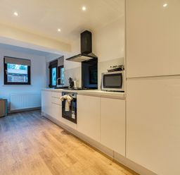 A kitchen with appliances and a window at Cabin 1 Moffat Manor Beaufort