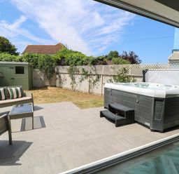 A garden with a hot tub and seating area at Cootiya Corner in Great Lyth