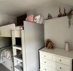 A bedroom with a bunk bed and a dresser at Penderyn Cottage Aberdare