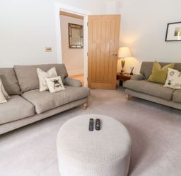 A living room with sofas and a coffee table at East View in Cheltenham