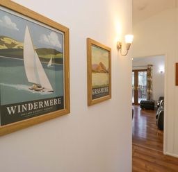 A hallway with framed posters at 6 Waterside Windermere