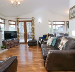 A living room with a television and seating area at 6 Waterside Windermere