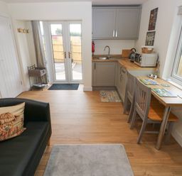 A kitchen with a table and chairs at Heidiaway Lodge in Gilfach Goch